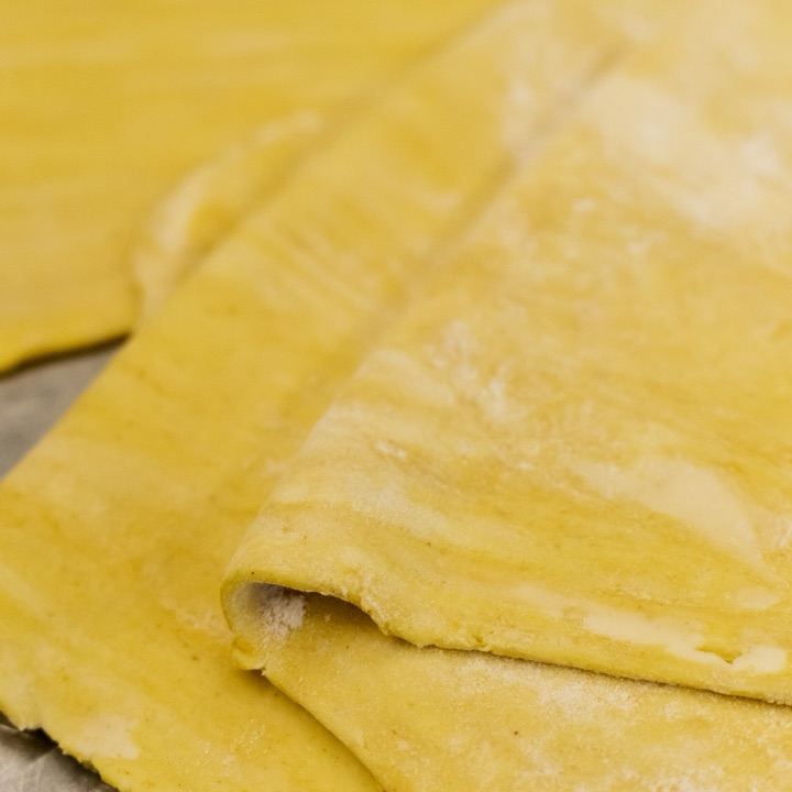 Close-up of laminated pattie dough showing its buttery layers